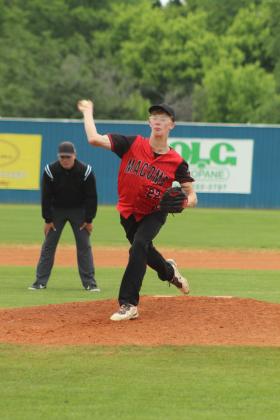 Macomb senior Conner Hutchins winds up his pitch during the first inning of the Class B District Baseball Tournament at Asher on April 22