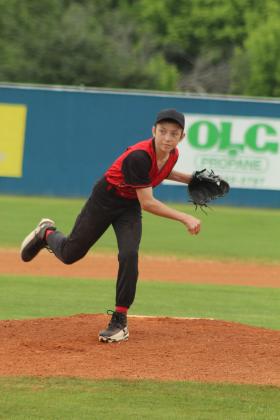 Macomb freshman William Rhea watches his pitch during the second inning of the Class B District Baseball Tournament at Asher on April 22.