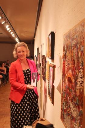 Lindsey Goodson of Tecumseh picked an apple painting by Josh Burnett at the annual "Off the Wall" event at the Mabee-Gerrer Museum of Art on April 24.