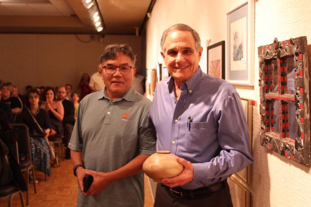 Artist Jason Kang, left, poses with John Fanelli after Fanelli chose a bowl created by Kang at the annual "Off the Wall" event at the Mabee-Gerrer Museum of Art on April 24.