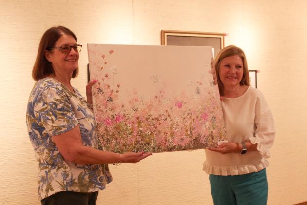 Joyce Stowers, also an artist, chose a work by Phyllis Bolt, right, at the annual "Off the Wall" event at the Mabee-Gerrer Museum of Art on April 24.