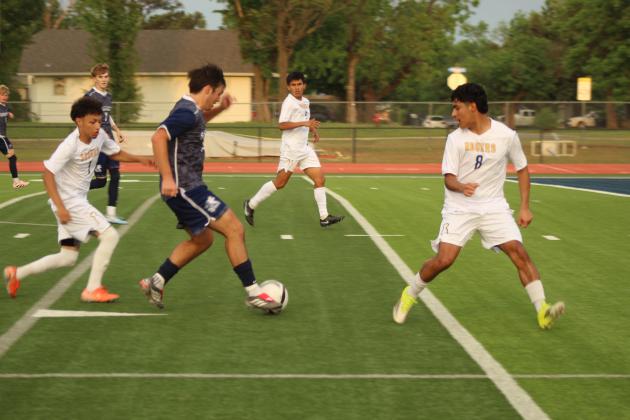 Shawnee's Jack Ford takes the ball up the field for a goal in the April 17 home game against Will Rogers. The Wolves won 4-3.