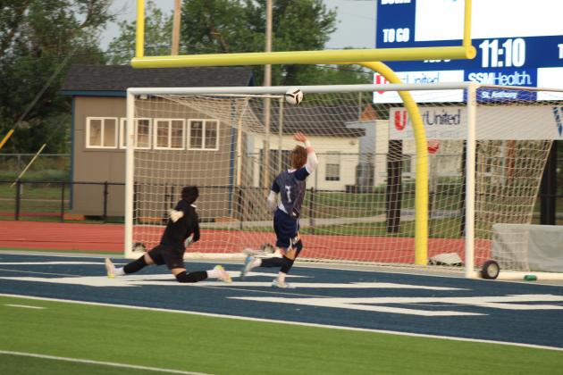Shawnee's Jace McDaniel kicked the ball above the goalie's head to score in the April 17 home game against Will Rogers. The Wolves won 4-3.