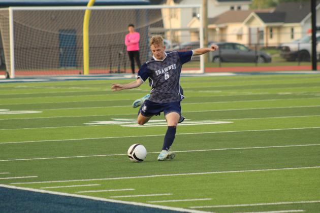 Shawnee's Zach Riggle passes down the field at the April 17 home game against Will Rogers. The Wolves won 4-3.