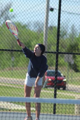 Shawnee sophomore Madalyn Rosenquist serves during the Shawnee East/West Quad Tournament on March 28.
