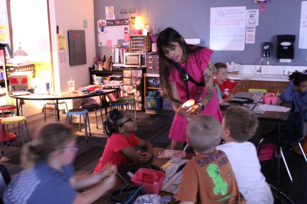 First-grade teacher Serena Neely, at Will Rogers Elementary in Shawnee, "candles" a duck egg to show her students how the duckling is growing - or if it has stopped - on April 16. Neely was the District Teacher of the Year for 2024-'25, and she is a top-10 finalist for State Teacher of the Year.