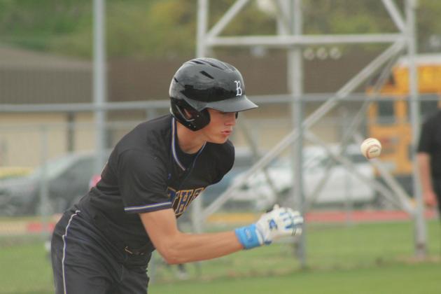 Bethel junior Hunter Brooks makes contact and runs to first base alongside the ball during the April 3 game at Tecumseh.