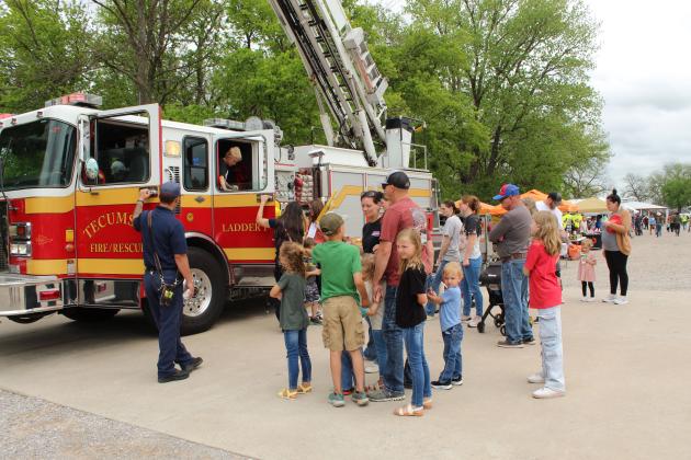 Families wait to tour the Tecumseh Fire &amp; Rescue fire engine during Touch-A-Truck and Beyond, held at the CPN Festival Grounds on April 11 and organized by Pottawatomie County Emergency Management. The Bethel and Shawnee fire departments were also onhand, along with law enforcement agencies and others.