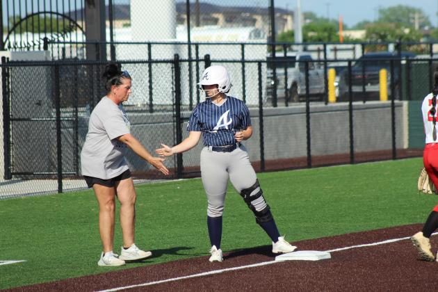 Asher sophomore Navaeh Griffin gets a low five from Head Coach Tari Dubler after hitting a triple during the April 16 game against Earlsboro in the Willie Stargell Slow Pitch Festival, held at FireLake Ball Fields. Asher won this game 8-0, as well as the game with Merritt that day, 6-1. Natasha Dunagan, Countywide &amp; Sun