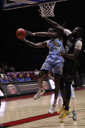 Potawatomi Fire Forward Jay Hedgeman goes to the hoop and is fouled in the third quarter of the May 14 home game against the Enid Outlaws. Hedgeman made 22 points and 11 rebounds for his second double-double this season. See full cutline below.