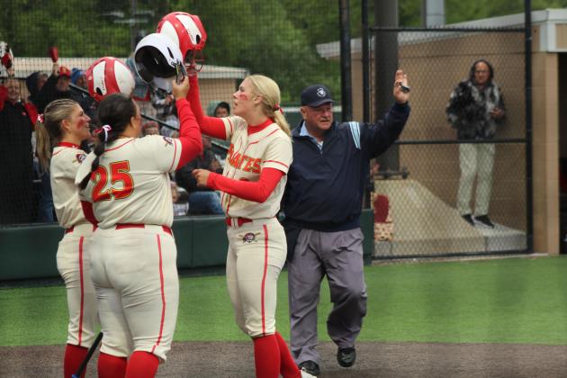 Dale junior Kinley Patten, right, hits helmets with her teammates after hitting a home run in the first inning of the Class 4A Slow Pitch State Championship game against Silo, held at FireLake Ball Fields on May 5. The Lady Pirates narrowly beat Silo, 18-17, as well as Coalgate, 14-5, and Howe, 15-0. They end their season with a record of 39-4.