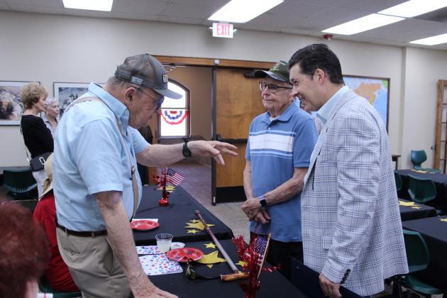 Air Force Veteran Glenn Peck, far left, introduces his former co-worker Gerald Farris, center, to State Senator Shane Jett during the Gold Star Families Reception at the Pottawatomie County Educational Veterans Museum, in Shawnee, on May 25. Farris lost a brother in the Vietnam War.