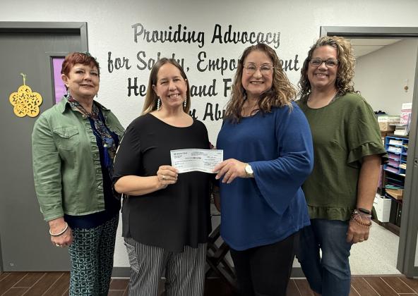 Fran Topping, Julie Talton, Renee Clemmons and Kristi Winchester pose with a check made out to Project:SAFE in the amount of $1025.00 from the Second Annual Rags 2 Runway event held April 25 at spOKeLAHOMA.