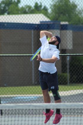 Shawnee senior Bryce Comstock serves on #1 Doubles with senior Benji Cole during the Shawnee NGB Tournament, held at SHS and OBU on May 2.
