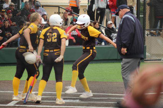 Supported by her teammates, Tecumseh junior Madison Gray steps on home plate after hitting a home run in the fifth quarter of the Class 5A Slow Pitch Quarterfinal game against Elgin, held at FireLake Ball Fields on May 5.