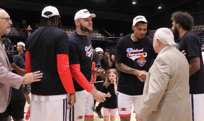 Potawatomi Fire Forward Isaiah Wade shakes hands with Citizen Potawatomi Nation Chairman John "Rocky" Barrett after proposing to his girlfriend, Triniti Foreman, following the Fire's fourth national championship finals win.