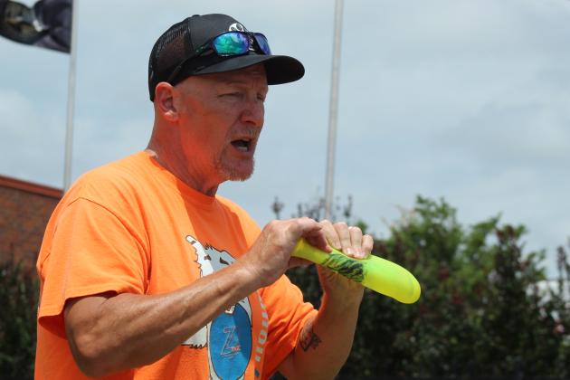 Jeff Savage with Tornado Alley Disc Dogs demonstrate how dog-friendly Frisbees should look when bent, with no white line along the middle.
