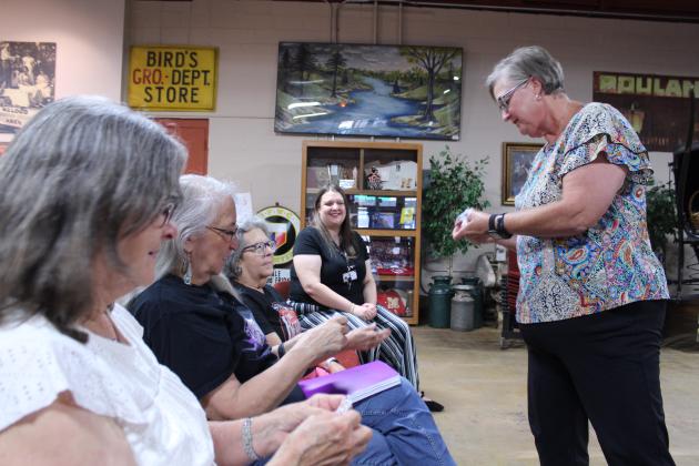 McLoud Head Librarian Lisa Lempges hands out Donald Duck stickers at the McLoud Museum and Historical Society, following the American Storytellers program.