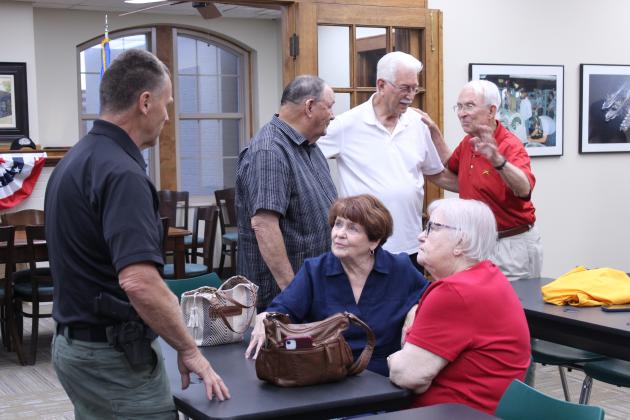 Sheriff Freeland Wood speaks with Linda Robinson and her sister Ann McDonald, as retired Brig. Gen. Ben Robinson talks to veterans Jerry Shiles and Bill Ford.
