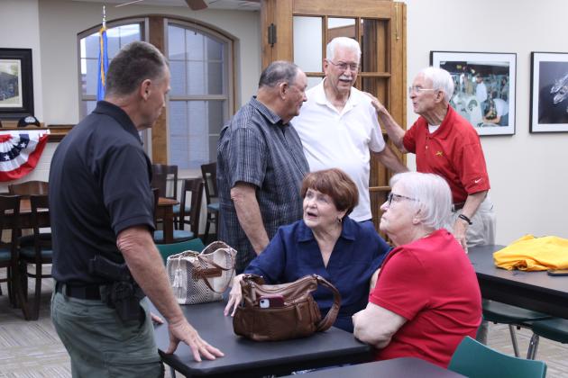 Sheriff Freeland Wood speaks with Linda Robinson and her sister Ann McDonald, as retired Brig. Gen. Ben Robinson talks to veterans Jerry Shiles and Bill Ford.