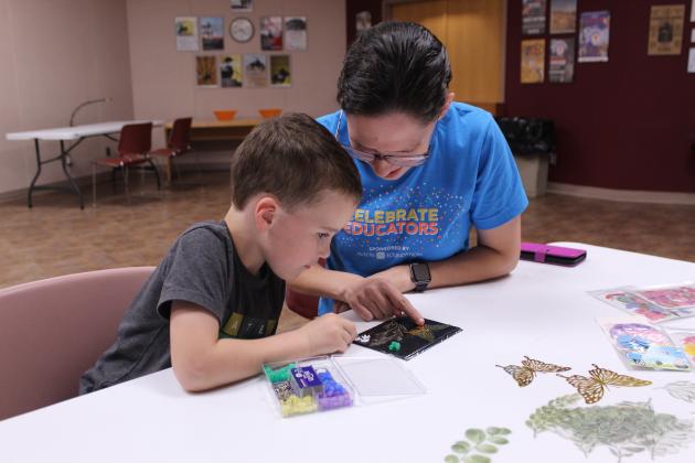 Natalie Chism and her son, Jacob Chism, 5, of Shawnee, plan their design for a cyanotype during Shawnee Public Library's "Creativity Unleashed" program on June 5.