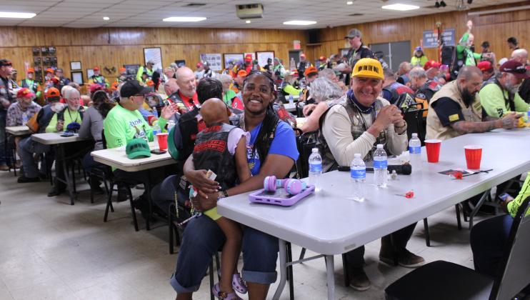 Taisha "Hitch" Harmon holds her four-year-old daughter, Valor, during the Run for the Wall stop at the Shawnee VFW on May 16, as David “Diamond” Camacho looks on. Harmon is an Army combat veteran with six years active duty, and she also conducts the RFTW Podcast with Ted "Boots" Kapner. This is the second year for Harmon and her daughter to participate in the ride, but their first time on the Midway Route.