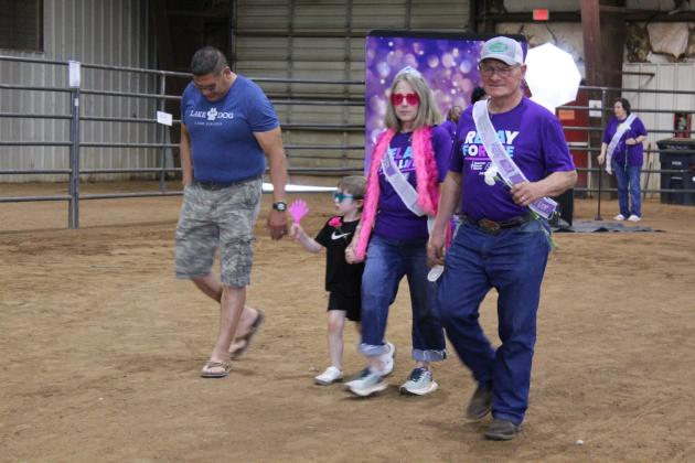 Deron SunEagle, Whitney SunEagle, grandson Timothy and Tommy Taron walk in the Caregivers' Lap of Relay for Life of Pottawatomie County on May 30 at the Heart of Oklahoma Expo Center Fred Humphries Arena. There were 54 registered survivors at RFL this year, and area teams raised $28,299 for the American Cancer Society.