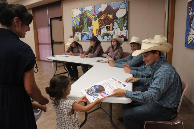IFYR Youth Directors sign posters at the Shawnee Public Library. File photo