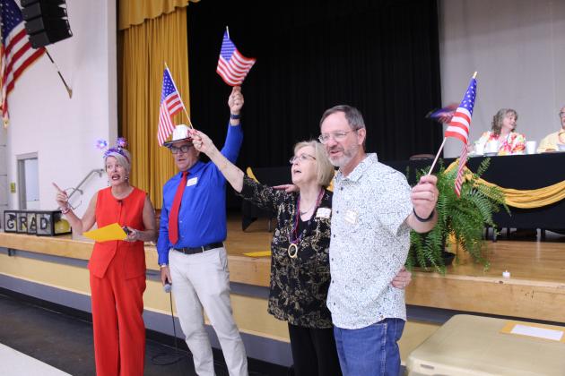 Cody (Rutledge) Swinson, Chase Rutledge, Carrol VanMeter and Mike Wolfinbarger lead the sing-along for "God Bless America" during the 124th Annual Tecumseh Alumni Banquet at the WP Wood THS Alumni Center on May 30.