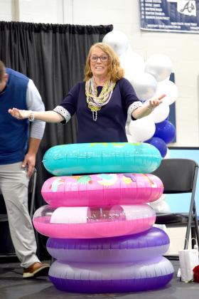 Shawna Magby, Asher High School Counselor, is adorned with pool floats -maybe as a thank you for keeping the Senior Class afloat.
