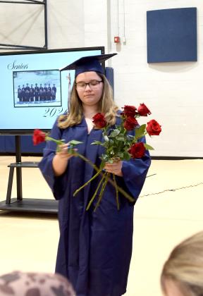 Kylee Atchley prepares to pass out roses to her family.