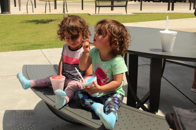 Twins Gypsy Miller and Gracelynn Miller, both 19 months old and from Shawnee, try snow cones during Freedom Fest 250, held at Woodland Veterans Park on July 2 in celebration of the 250th USA anniversary.