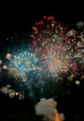 As the grand finale lights up the sky, you are able to see a plume of smoke hangs in the air just below the the skyline.