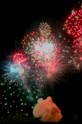 As the grand finale lights up the sky, you are able to see a plume of smoke hangs in the air just below the the skyline.
