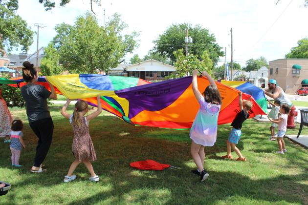 Families play with a parachute during Freedom Fest 250, held at Woodland Veterans Park on July 2 in celebration of the 250th USA anniversary.