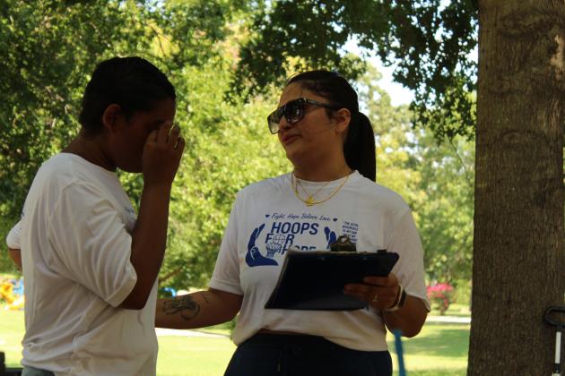 Isabella McCoy speaks about her best friend, J-Lynn Haymond, and their first fundraiser, Hoops for Hope, which was held at the Rotary Briscoe Boy Scout Park on July 25. A total of $310 was raised for the American Cancer Society from a 3x3 basketball tournament, a fun run, silent auction and the Cali4Ya LLC taco truck.
