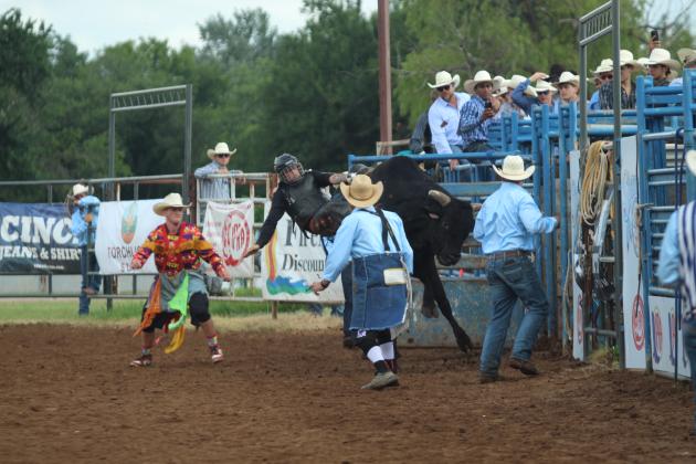 Colton Johnson of Shawnee hangs on in the bull riding event of the International Finals Youth Rodeo on the morning of July 13.