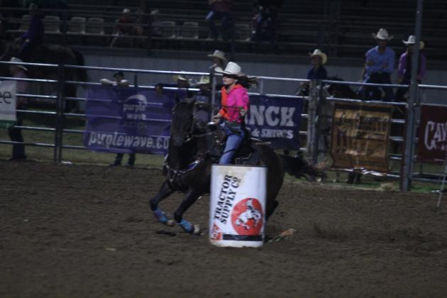 Sydney Johnson of Tecumseh steers around the second barrel in the barrel racing event of the International Finals Youth Rodeo on the evening of July 13.