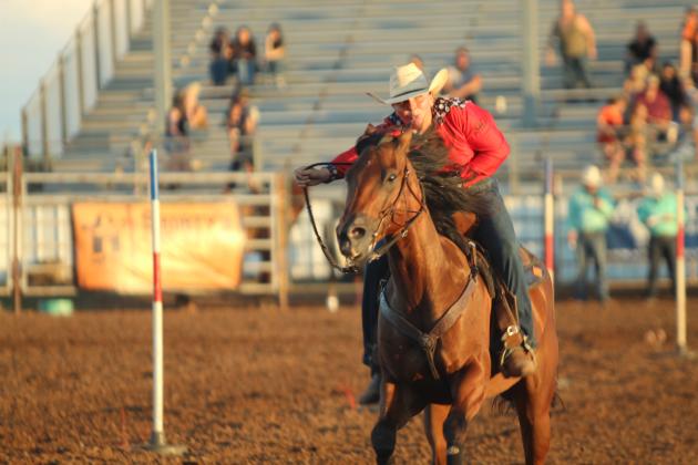 Ember Lane of Meeker looks for her time in the pole bending event of the International Finals Youth Rodeo on the evening of July 13.