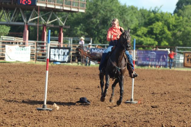 Rylin Youngblood of Maud makes her way around the poles and her hat in the pole bending event of the International Finals Youth Rodeo on the morning of July 13.