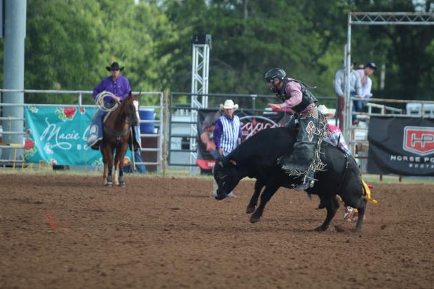Caid McCullar of Trona, CA, takes his ride in the bull riding event of the International Finals Youth Rodeo on the morning of July 14.