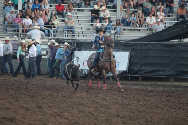 Bileigh Jernigan of McLoud smiles after lassoing her calf in the breakaway roping of the IFYR on the evening of July 15.