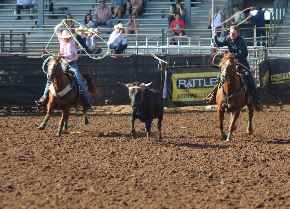 Phoenix Rawls of Tecumseh, left, and Paden Rawls of Wewoka compete in the team roping event during the IFYR on the morning of July 16. They placed 10th in the overall event standings.