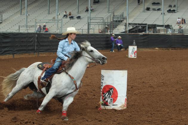 Brenna Beauchamp of Wanette takes her "running gray" around the third barrel during the IFYR on the morning of July 17.