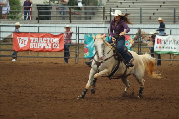 Cassidy Wilson of Shawnee runs her horse to the third barrel during the IFYR on the morning of July 17.