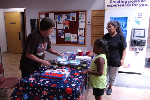 Mary Sims serves cake to Leslie Straight and Kataleya King, 5, both of Shawnee.