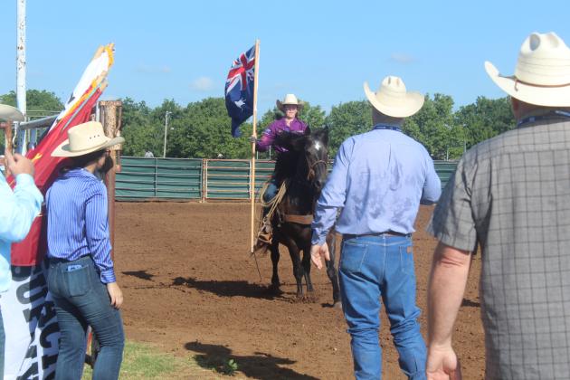 A member of Team Australia carries their country's flag on the morning of July 13 at the IFYR.