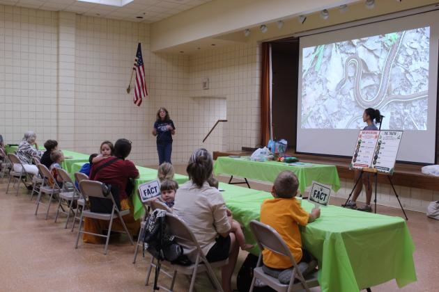 Kristy Wicker, of Wild Care Oklahoma, speaks about the benefits of snakes during the" Misunderstood, Not Mean: Skunks, Coyotes &amp; Other Wild Neighbors" Tecumseh Public Library program on July 22. With the assistance of rehabilitation staff member Iris Hoyer, Wicker also presented facts about skunks, coyotes, bats, owls and spiders. Attendees could put stickers on their animal passports and make necklaces, as well. Visit www.pioneerlibrarysystem.org to see upcoming events.