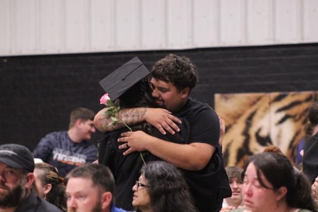 Kambrea Siqueiros gets a hug after presenting a pink rose during Maud High School's Graduation on May 22 at the Ed Harman Gymnasium.