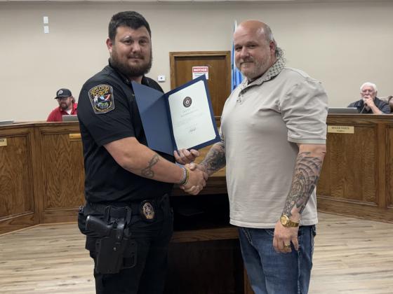 FOP President Chris Bacon gave an award to John Wasson for his eforts to assist the police department with the Blackberry Festival and other city events. Julie Talton, Countywide &amp; Sun